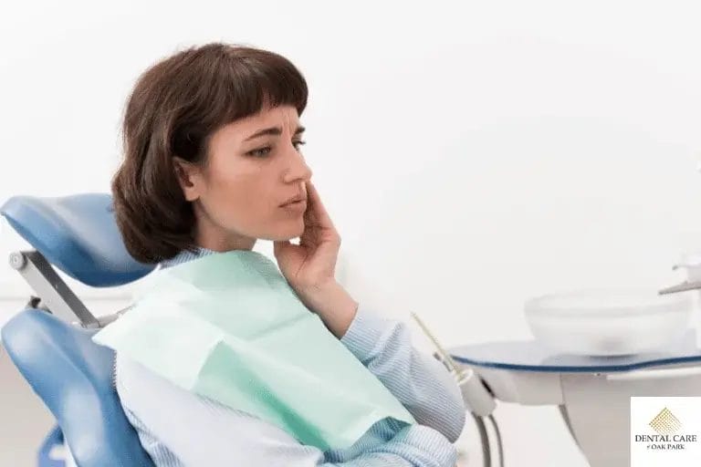 Woman touching cheek concerned about wisdom tooth recovery